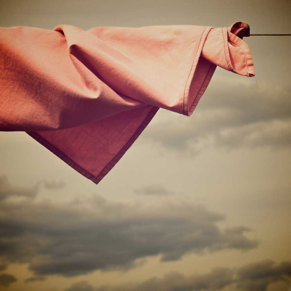 Salmon colored cloth in a clothesline