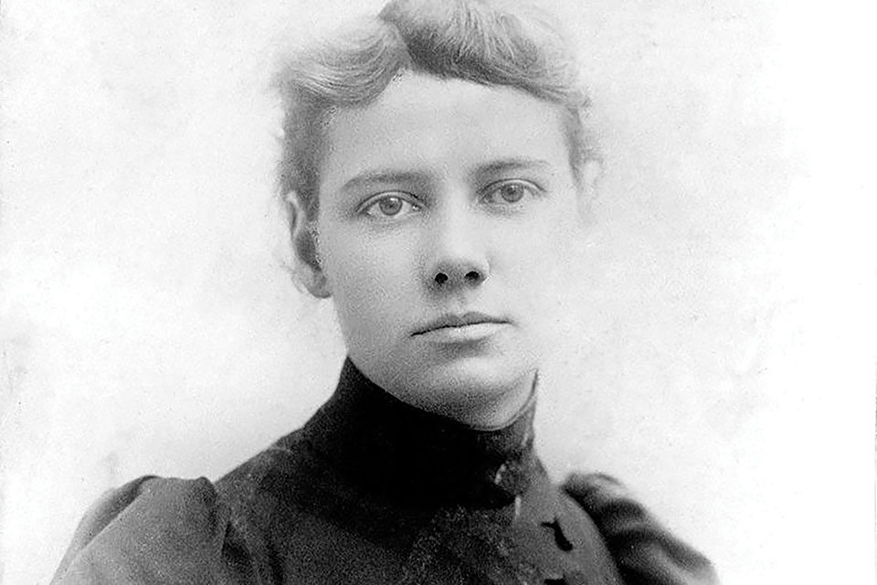 A black and white photograph of Nellie Bly, a pioneering female reporter.