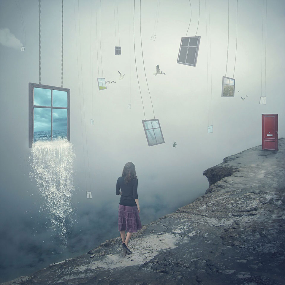 A digitally manipulated photo. A female walks away from the viewer along a cliff's edge towards a red door. Windows hang in the sky nearby, the largest of which is gushing water,.