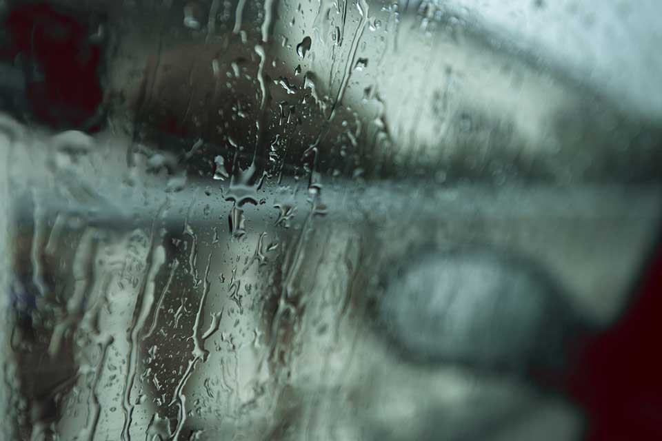 A photograph of a rain-streaked window