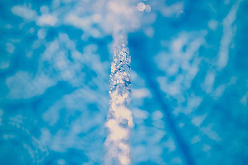 A close-up photograph of water running into a bath