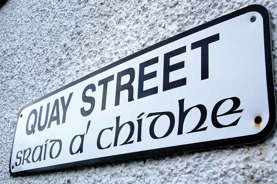 A photograph of a sign that reads (in English) Quay Street with the Gaelic translation printed below