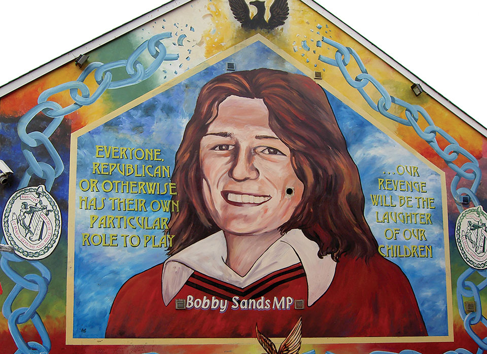 A mural with a painting of Bobby Sands. The text reads “Everyone. Republican or otherwise has their own particular role to play...our revenge will be the laughter of our children.” 