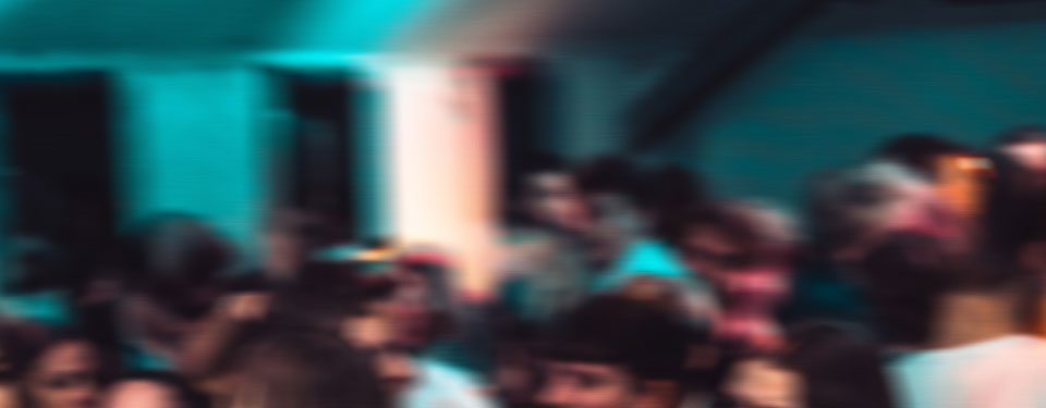 A blurry photograph of people at a party