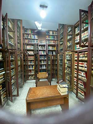A fish eye photograph of a library through a window in the door