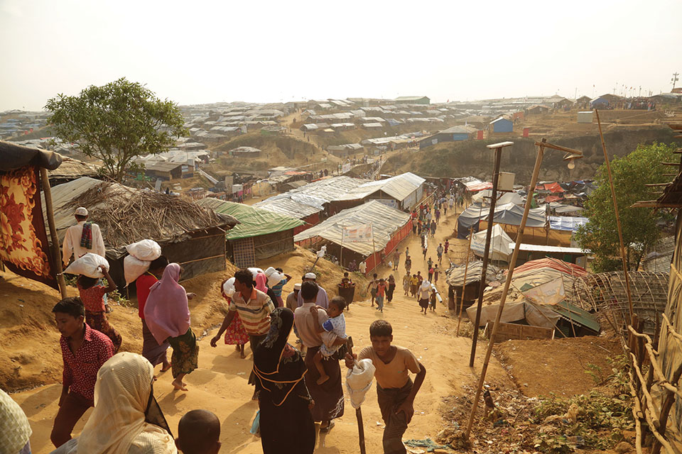 A photograph shot from a high vantage that shows refugees streaming in and out of the Kukupalong refugee camp