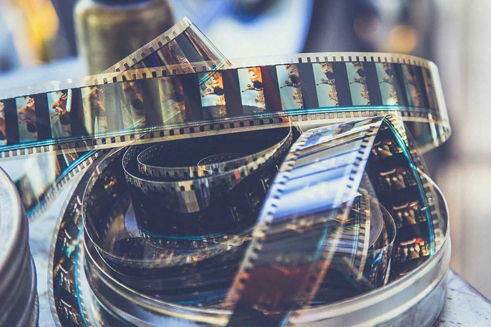 A coil of motion picture film is coming uncoiled