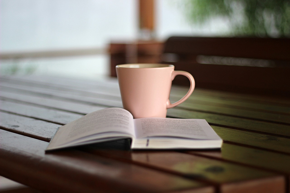 Coffee and a book on a table