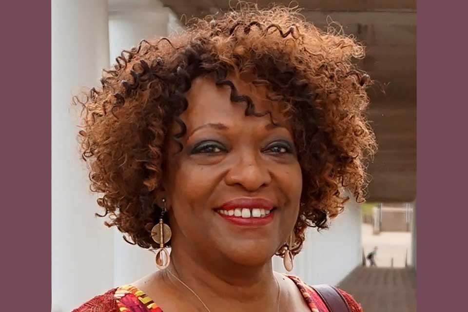 A photograph of Rita Dove, who is smiling while looking at the photographer