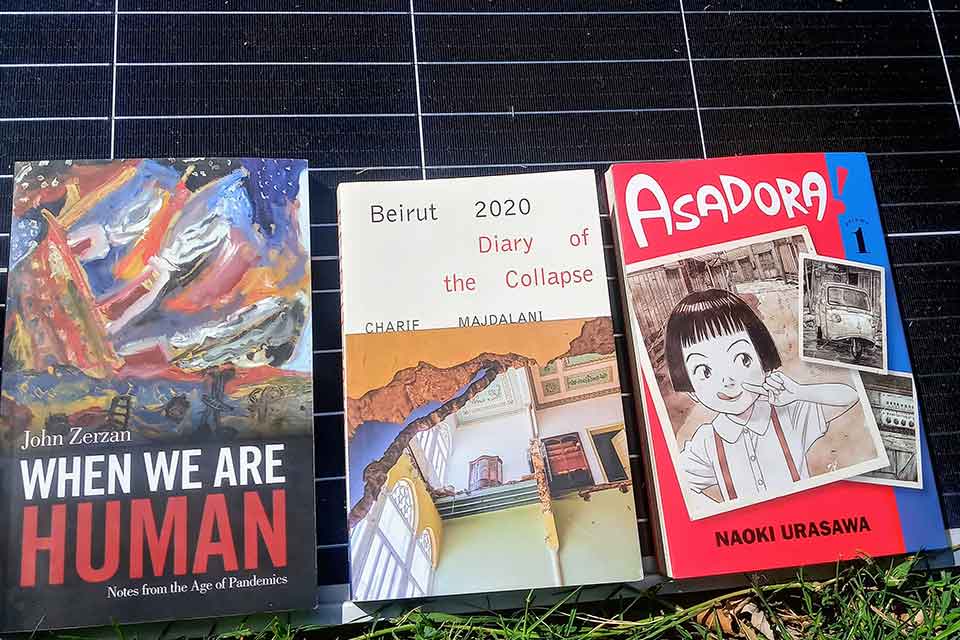 The three books discussed in the list below displayed on the face of an upright solar panel