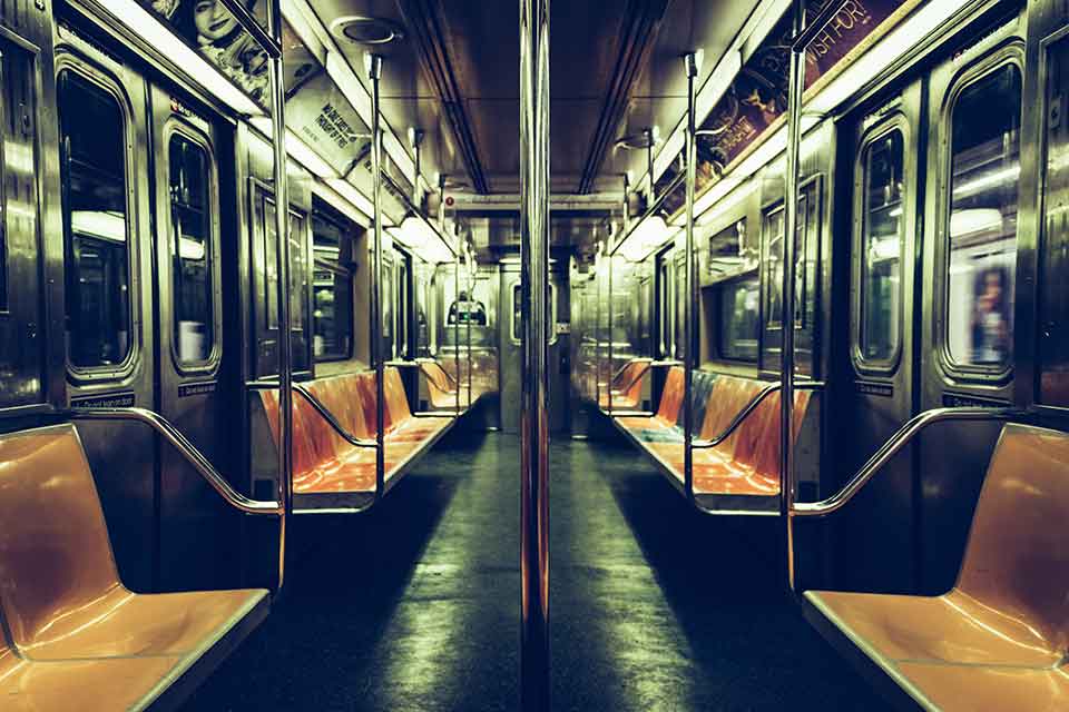 A photograph of the long interior of a subway car