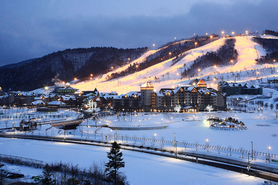 A snowy hillside landscape with the city of PyongCheong at its base.