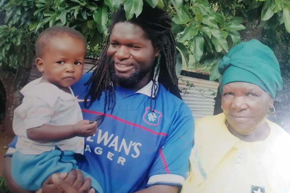 A photograph of Vonani Bila with his mother and his son