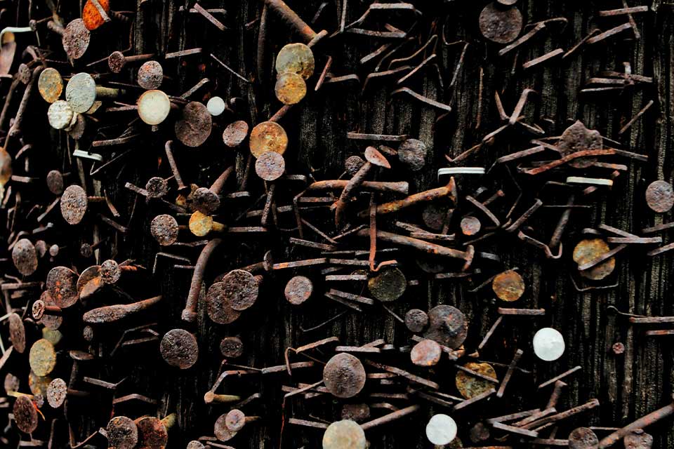 A photograph of a pile of rusty thumb tacks