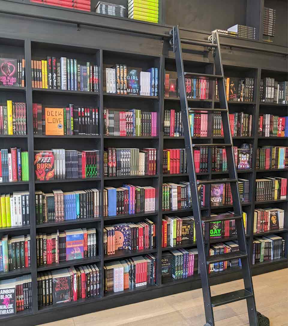 A photograph of a large wall of books