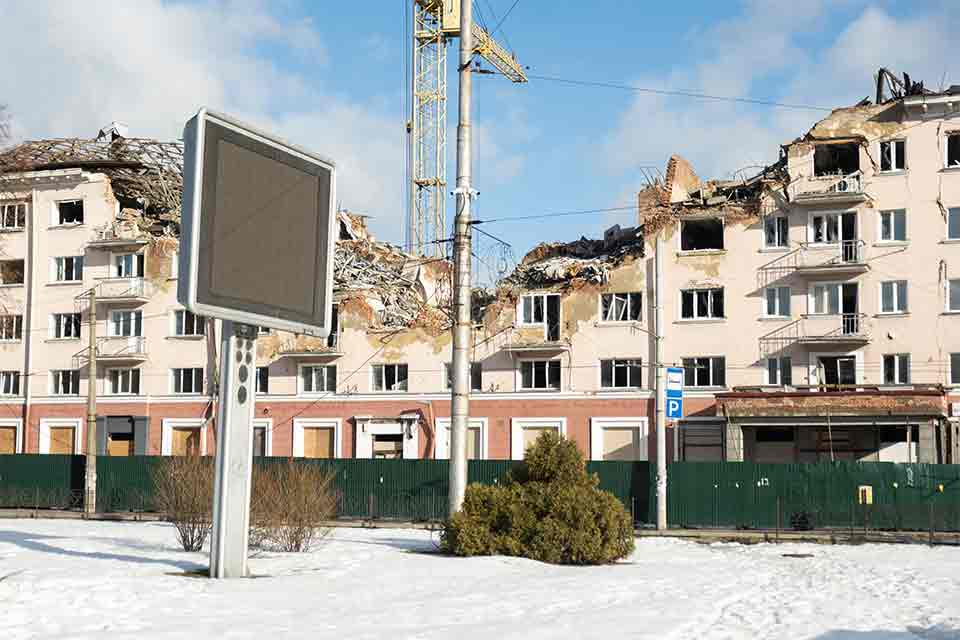 A photograph of a bombed out apartment block