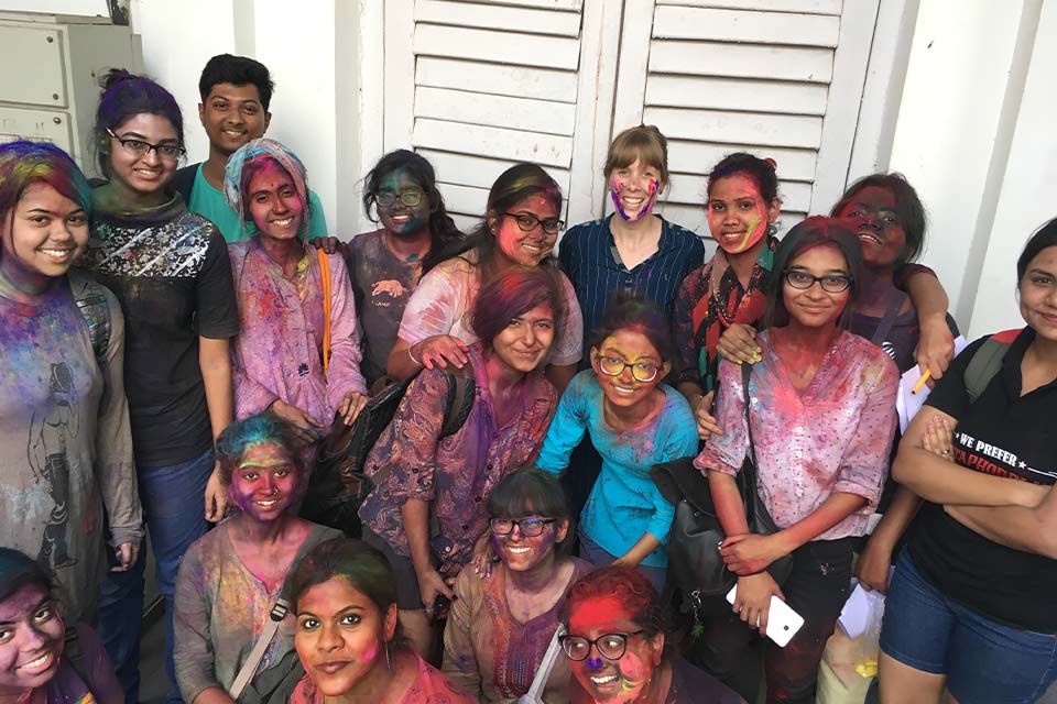 A photograph of young people covered in chalk from Diwali