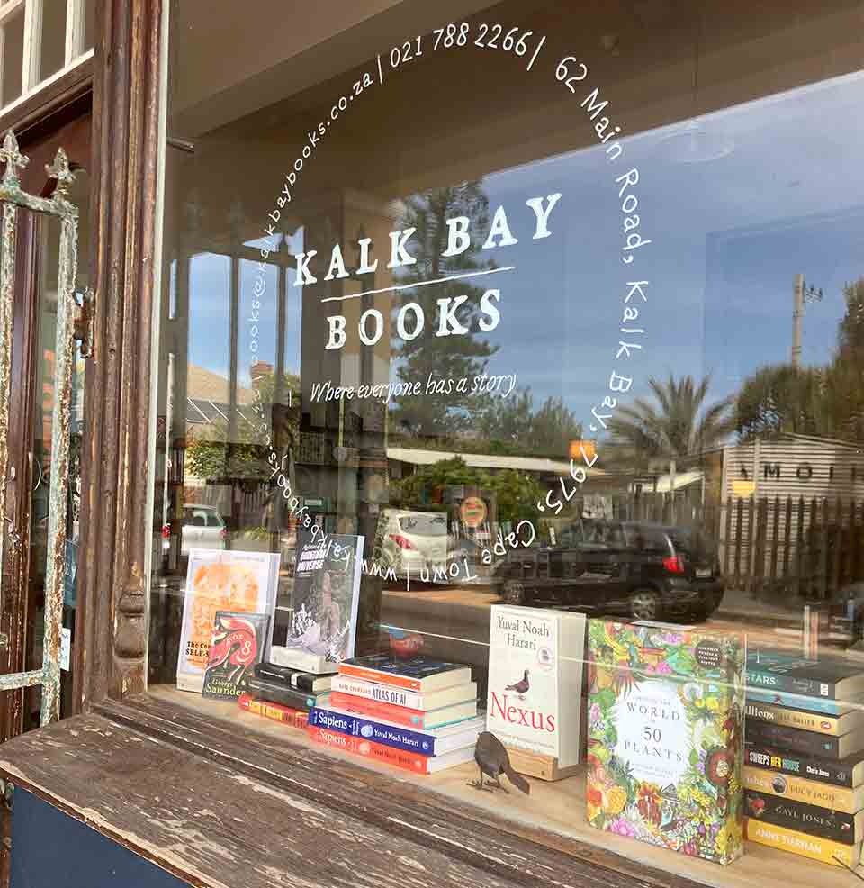 The exterior of a bookstore. Text read: Kalk Bay Books. Where Everyone Has a Story