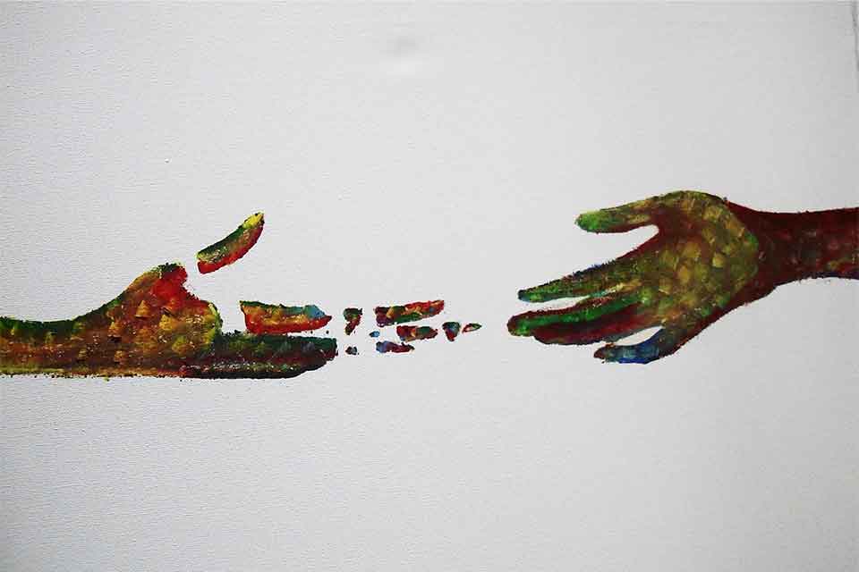 An illustration of two hands reaching out to one another. One hand is crumbling