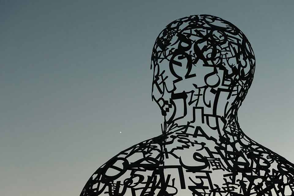 A sculpture that uses letters and words to form a humanoid shape