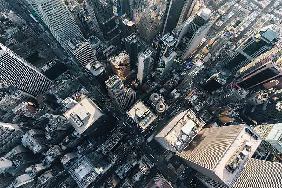 An aerial view of New York looking down on a skyscraper