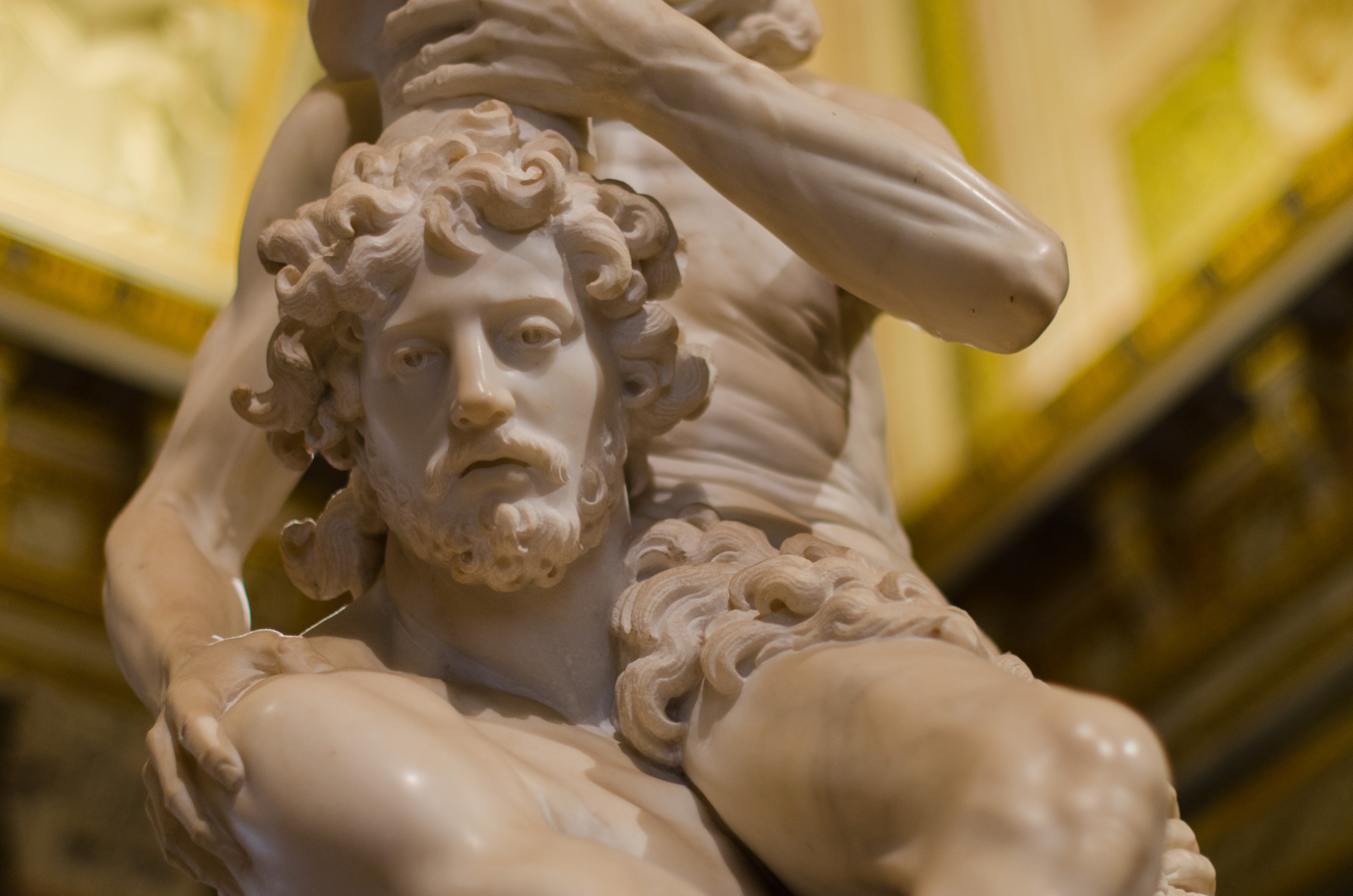 A photographic detail from a sculpture of a beaded male figure