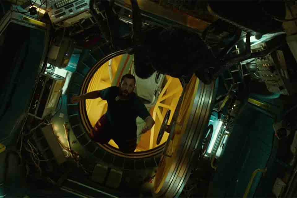 A figure floats in the open doorway of a spaceship