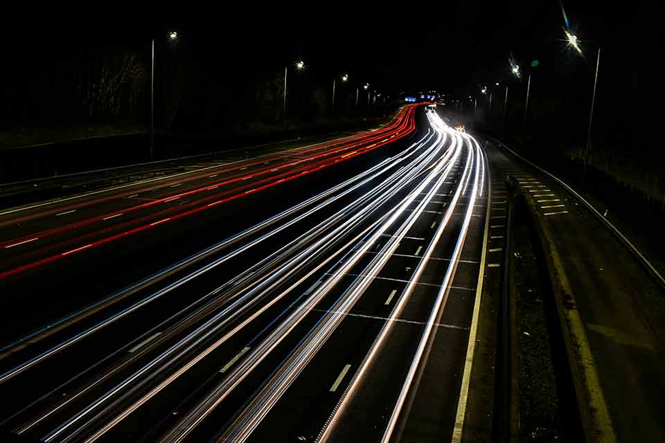 A time-elapsed photograph of cars on a highway at night