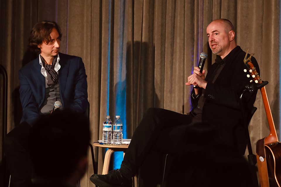 Patricio Ferrari and Nikola Madžirov conversing on a stage