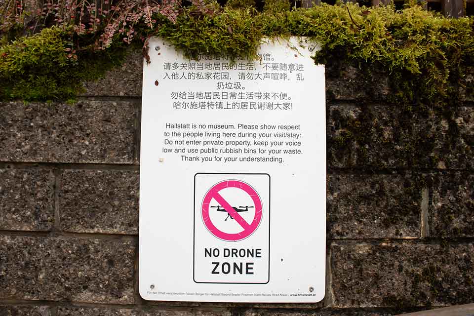 A sign asking visitors to exercise restraint when visiting Halstatt