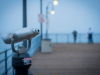 A photograph of pier binoculars, shrouded in fog