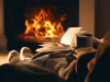 A photograph of a person sitting in front of a fire reading