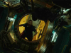 A figure floats in the open doorway of a spaceship