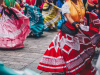 The lower torso of women in traditional Mexican dress dancing in tandem