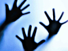 Three hands pressing against glass