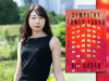 Rie Qudan with the cover to her book Sympathy Tower Tokyo