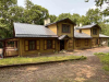 The Markučiai Manor Museum: A rough hewn wooden home surrounded by trees