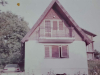 A faded color photograph of an old farm house