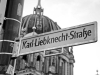 A black and white photograph of a street sign that reads Karl Liebknecht Straße