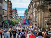A photograph of a busy street, filled with people, in Glasgow