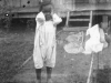 A double exposed black and white photograph of a young African American child with a women seated perpendicular to the main image