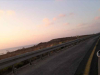 A photograph of a road as seen from a car window