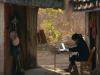 A photograph of Yu Xiuhua writing on a laptop