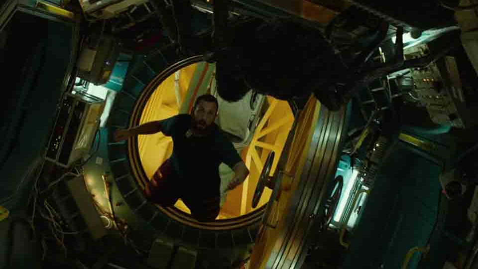 A figure floats in the open doorway of a spaceship
