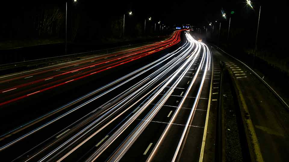 A time-elapsed photograph of cars on a highway at night