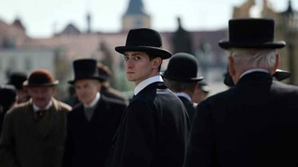 A man in a group of men dressed in suits looks at the viewer