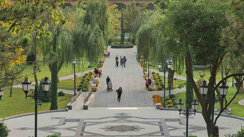 A paved walkway juts out into a natural landscape in an urban park