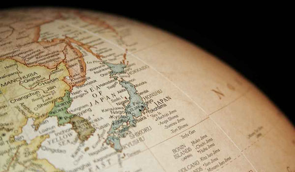 A detail of a globe that is rotated to display Japan and Korea