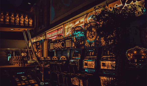 A photograph of a wall of slot machines, rendered through a surreal reverse image filter