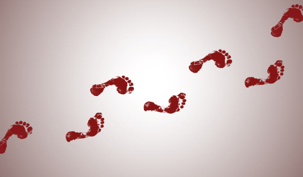 Footprints made in red across a white surface